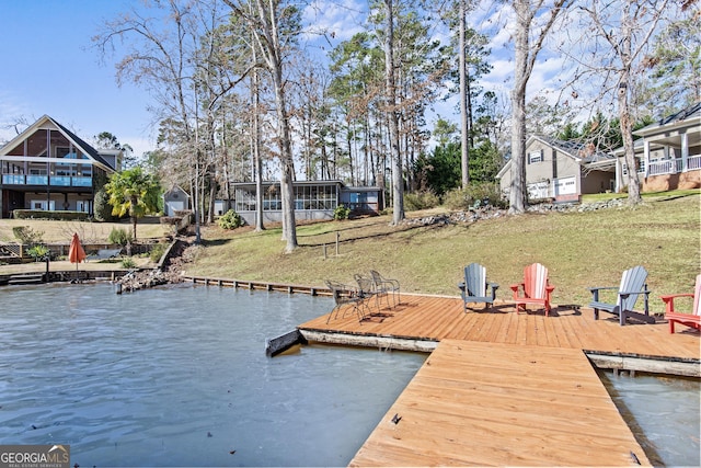 view of dock featuring a yard and a water view