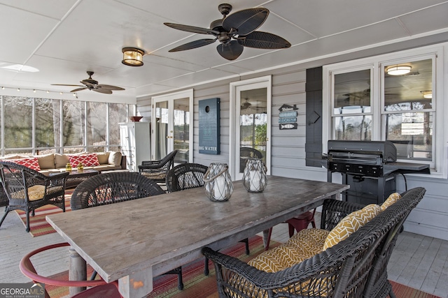 sunroom / solarium featuring ceiling fan