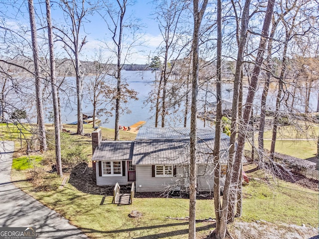 view of front of home with a water view and a front yard