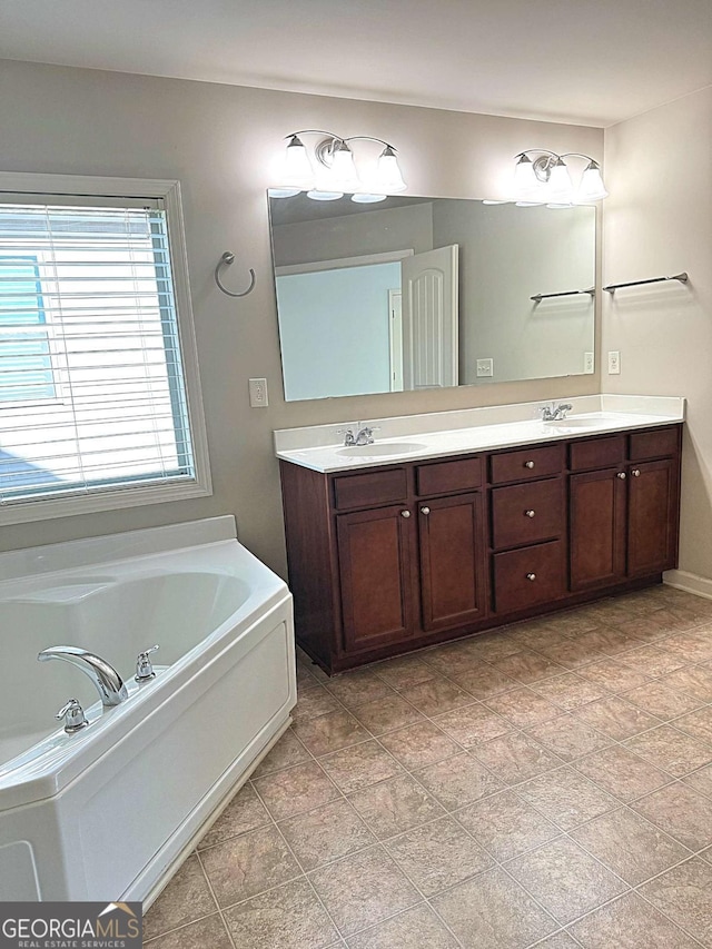 bathroom with vanity and a bath