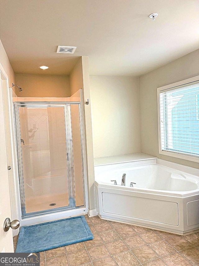 bathroom featuring plus walk in shower and tile patterned floors