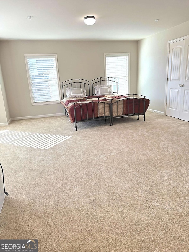 bedroom featuring light colored carpet