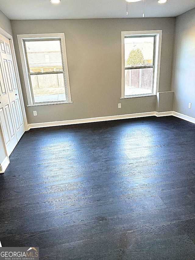 empty room featuring dark wood-type flooring