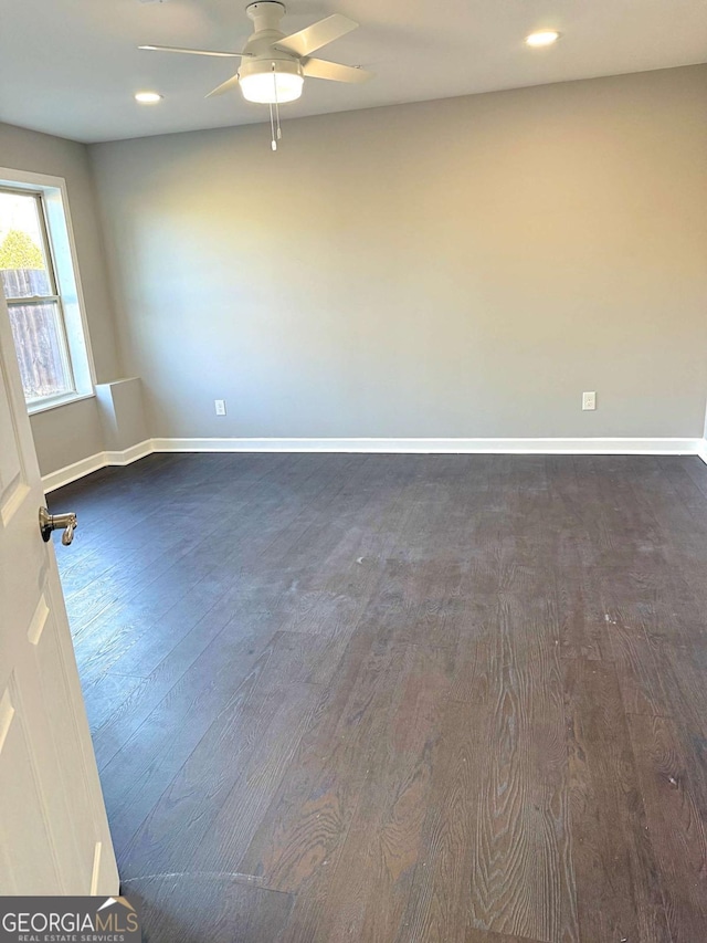 unfurnished room featuring ceiling fan and dark hardwood / wood-style flooring