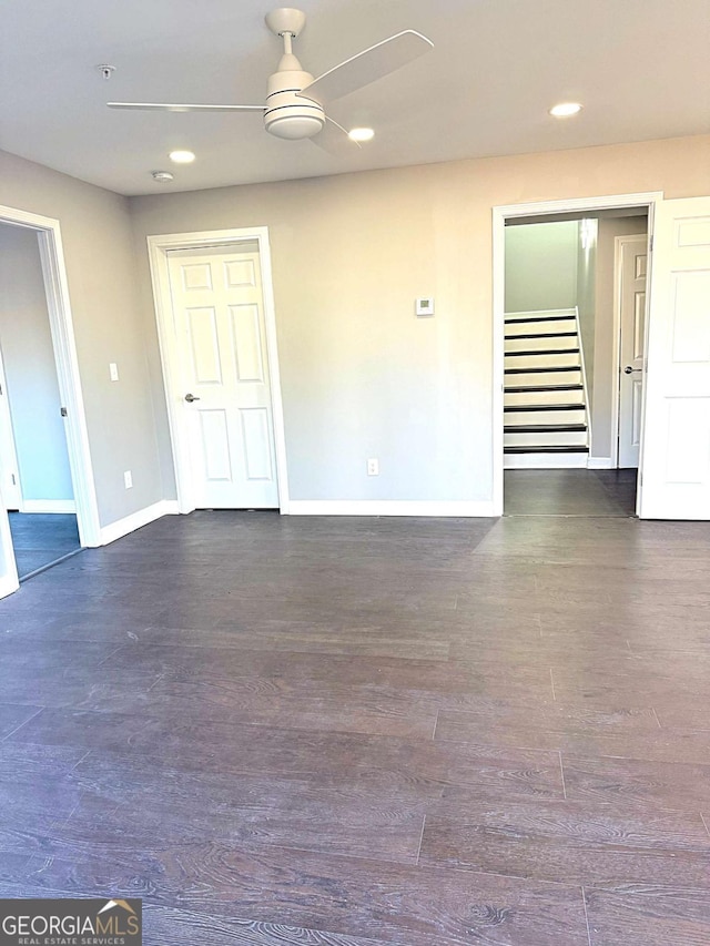 spare room featuring ceiling fan and dark hardwood / wood-style floors