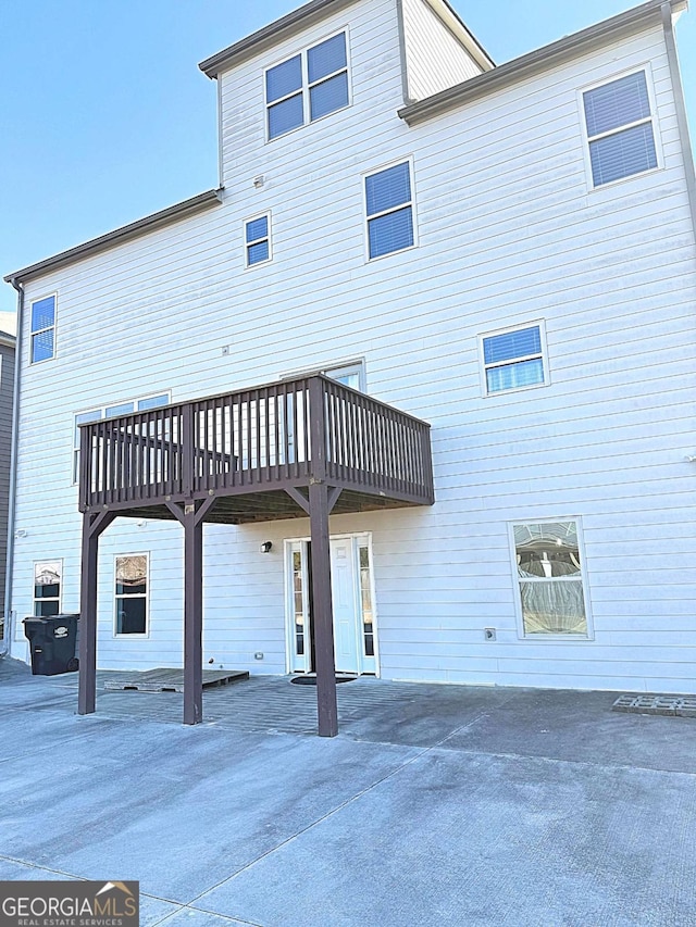 back of house featuring a wooden deck