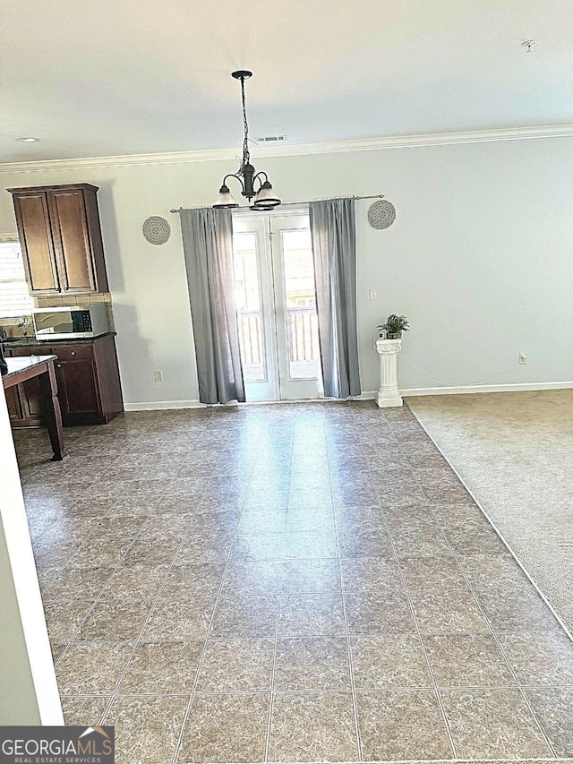 unfurnished dining area with crown molding