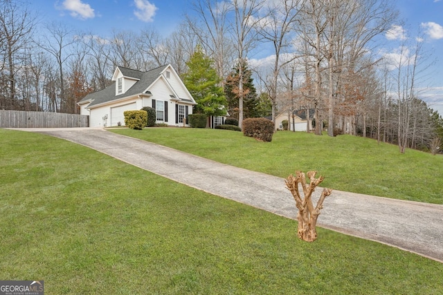 view of front of property featuring a garage, a shingled roof, fence, driveway, and a front lawn