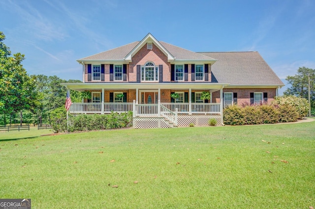 colonial inspired home with a front yard and a porch