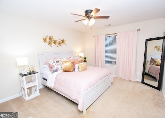 bedroom featuring light colored carpet, visible vents, and baseboards