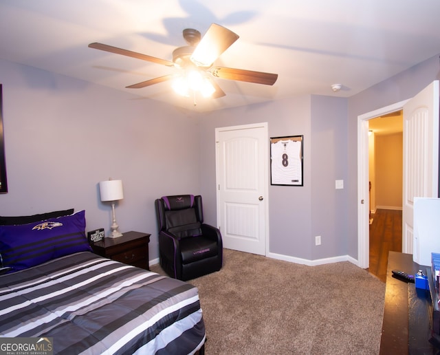 carpeted bedroom with ceiling fan and baseboards