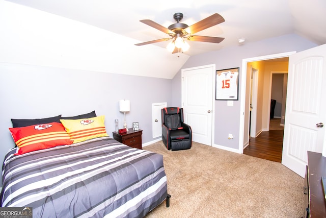 carpeted bedroom with a ceiling fan, lofted ceiling, and baseboards