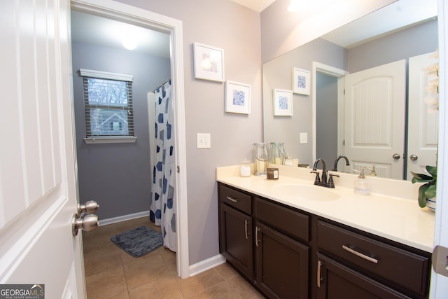 full bathroom with baseboards, curtained shower, vanity, and tile patterned floors