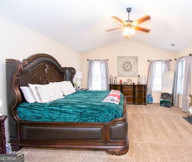 carpeted bedroom featuring vaulted ceiling, multiple windows, visible vents, and baseboards