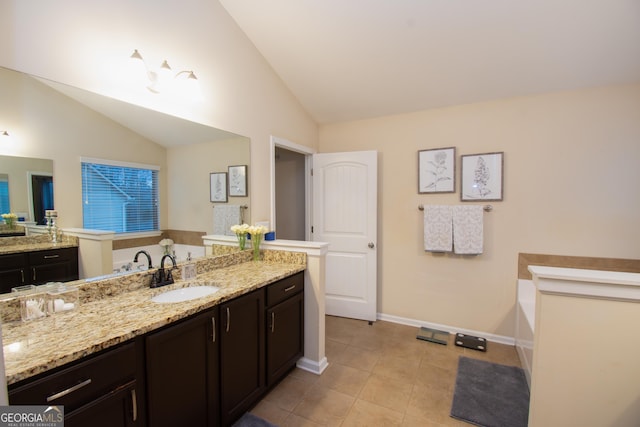 bathroom with lofted ceiling, tile patterned flooring, two vanities, a sink, and baseboards