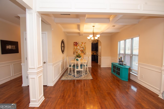 unfurnished dining area with coffered ceiling, dark wood-style flooring, beamed ceiling, an inviting chandelier, and a decorative wall