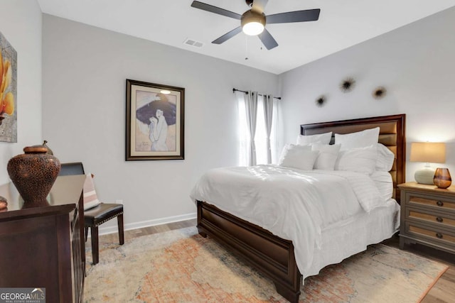 bedroom with light hardwood / wood-style flooring and ceiling fan