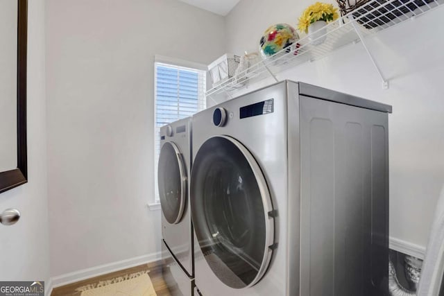 laundry area with hardwood / wood-style flooring and independent washer and dryer