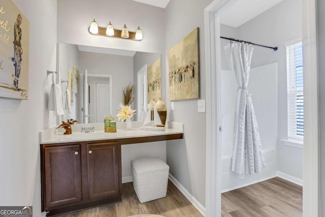 bathroom featuring shower / bathtub combination with curtain, vanity, and hardwood / wood-style flooring