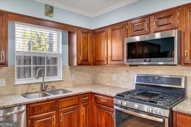 kitchen featuring a sink, tasteful backsplash, appliances with stainless steel finishes, crown molding, and light stone countertops