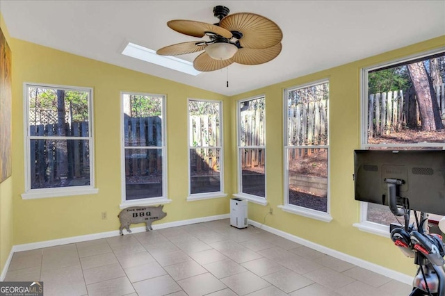 unfurnished sunroom featuring vaulted ceiling with skylight and ceiling fan