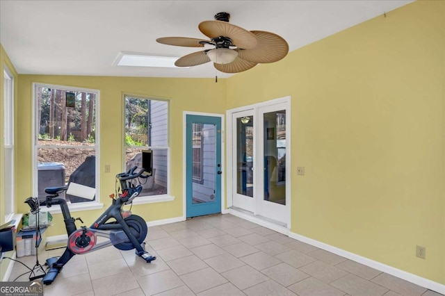 workout room featuring tile patterned floors, baseboards, a ceiling fan, and lofted ceiling