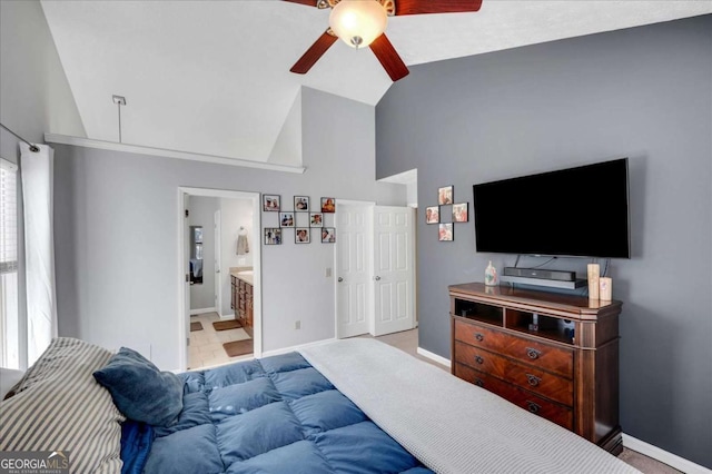 bedroom featuring connected bathroom, baseboards, lofted ceiling, carpet flooring, and a ceiling fan