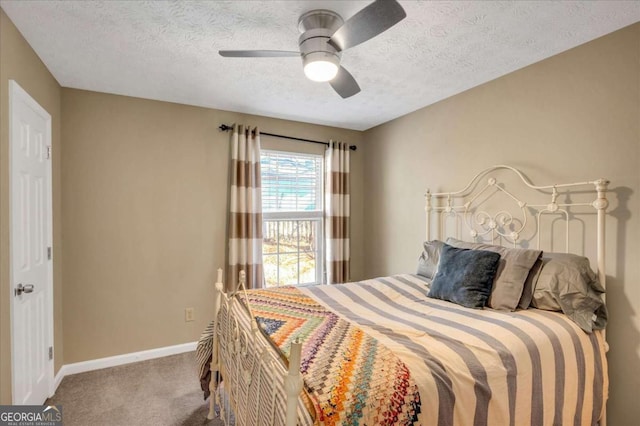 bedroom with a textured ceiling, carpet, baseboards, and ceiling fan