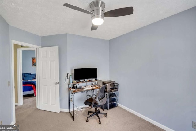 office with a textured ceiling, a ceiling fan, baseboards, and carpet floors