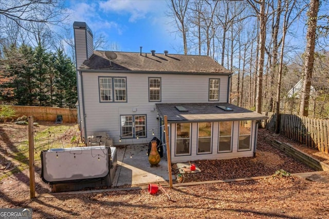 rear view of property with a patio, fence private yard, and a chimney