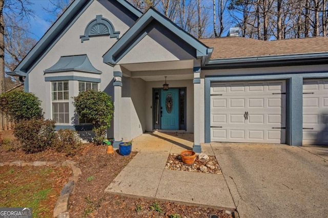 ranch-style house featuring a shingled roof, a garage, driveway, and stucco siding