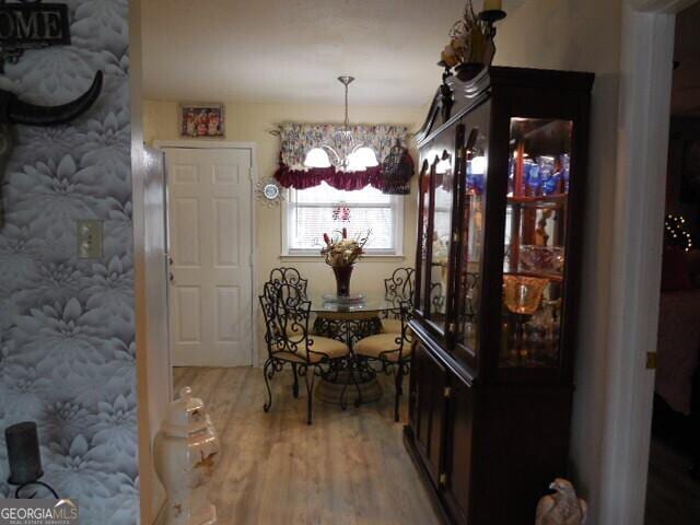 dining room with hardwood / wood-style floors and a chandelier