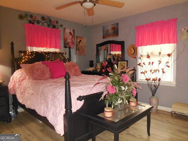 bedroom featuring hardwood / wood-style floors and ceiling fan