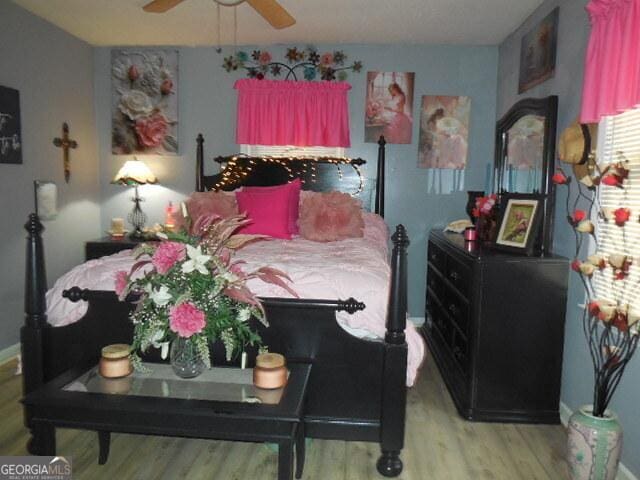 bedroom with ceiling fan and light hardwood / wood-style floors