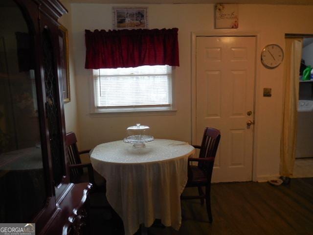 dining space with dark hardwood / wood-style flooring