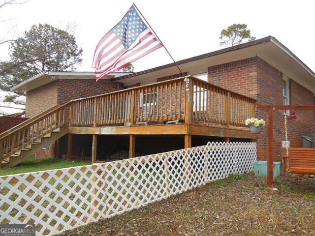 back of property featuring a deck