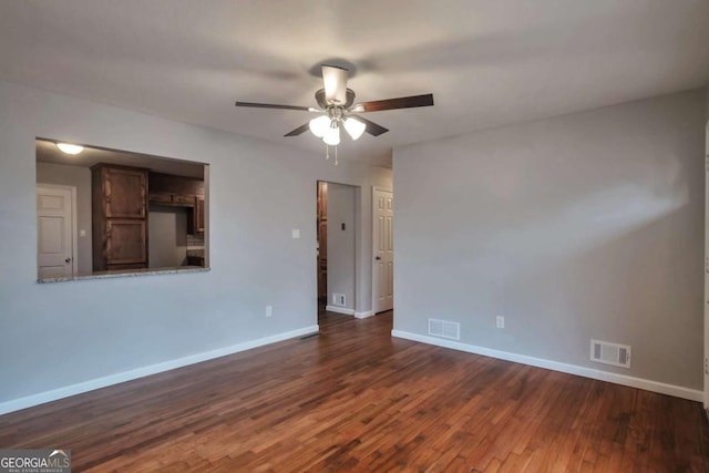 spare room with dark hardwood / wood-style floors and ceiling fan