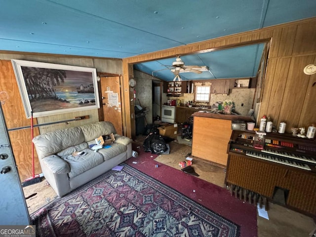 living room featuring lofted ceiling, wooden walls, and ceiling fan