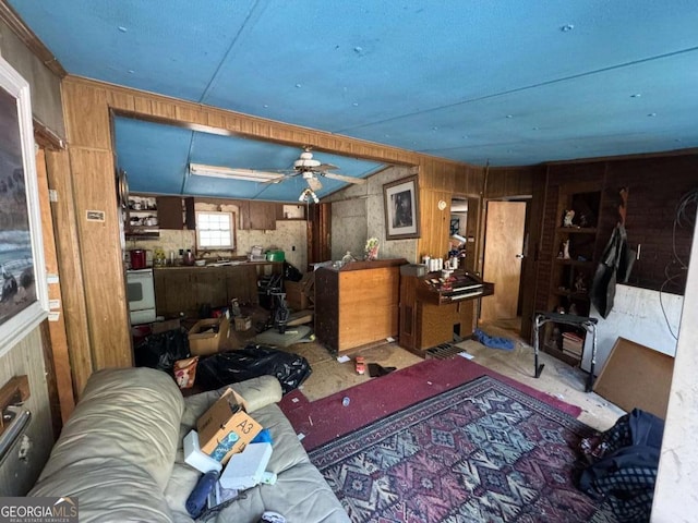 living room with ceiling fan and wooden walls