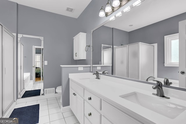 bathroom featuring tile patterned flooring, visible vents, and a sink