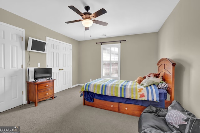 carpeted bedroom with a ceiling fan, a closet, visible vents, and baseboards