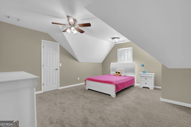 carpeted bedroom featuring baseboards, vaulted ceiling, visible vents, and ceiling fan