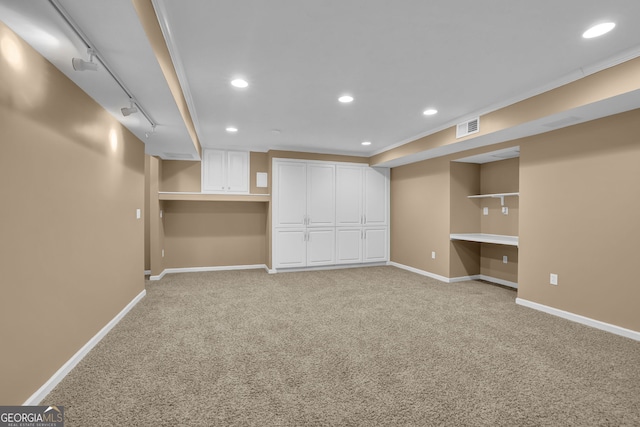 below grade area featuring recessed lighting, light colored carpet, visible vents, baseboards, and built in study area