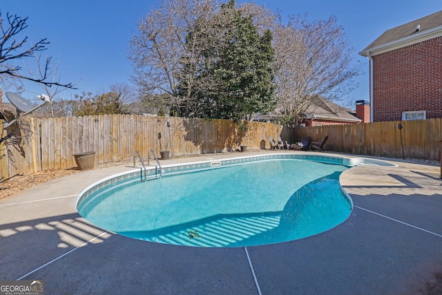 view of pool featuring a patio, a fenced backyard, and a fenced in pool