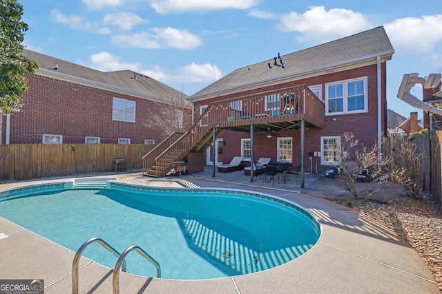 view of swimming pool with a fenced in pool, a fenced backyard, stairs, a wooden deck, and a patio area