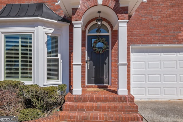 property entrance with a standing seam roof, brick siding, and metal roof