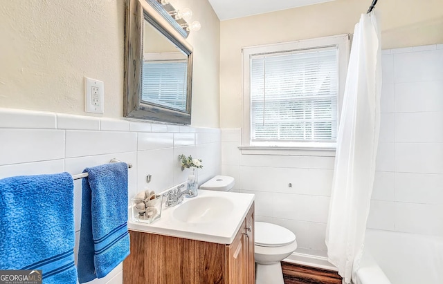 full bathroom featuring shower / tub combo, toilet, tile walls, wood-type flooring, and vanity