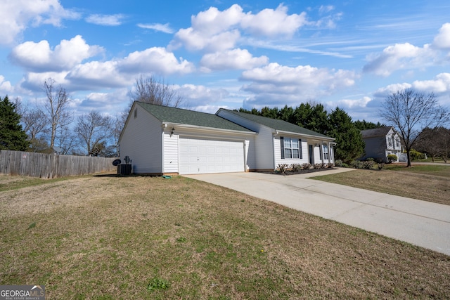 view of front of home featuring a garage, a front yard, concrete driveway, and fence