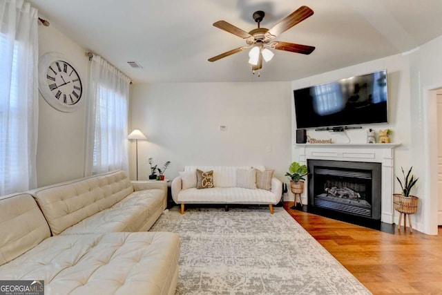 living room featuring hardwood / wood-style flooring and ceiling fan