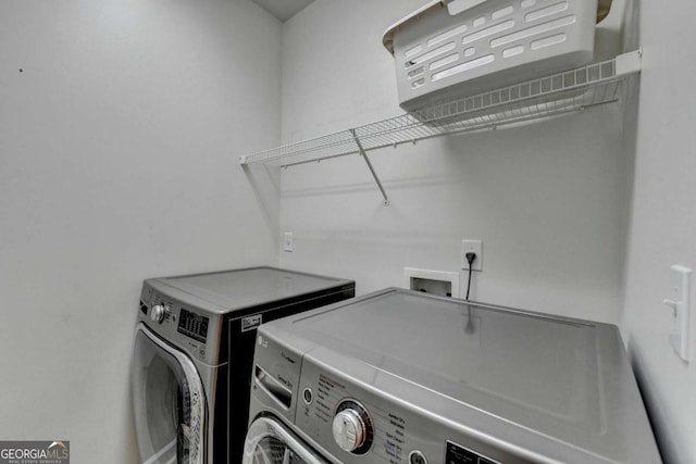 clothes washing area featuring washing machine and dryer